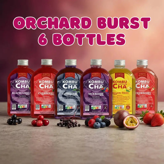 KombuCha bottles in fruit flavors with fruits on a wooden surface and gradient background.